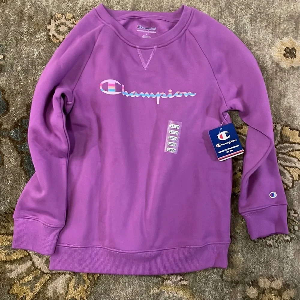 Children’s magenta long sleeved sweatshirt by Champion. Size large.NWT.